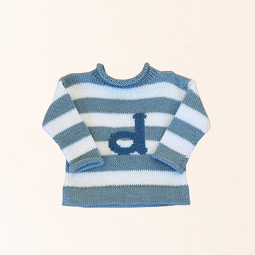 Blue and white striped sweater with a logo on a light beige background