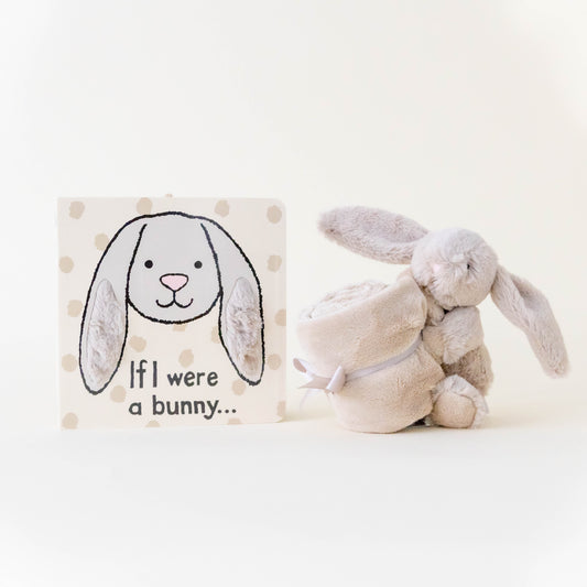 Beige bunny stuffed animal and book titled "if I were a bunny" on a neutral background