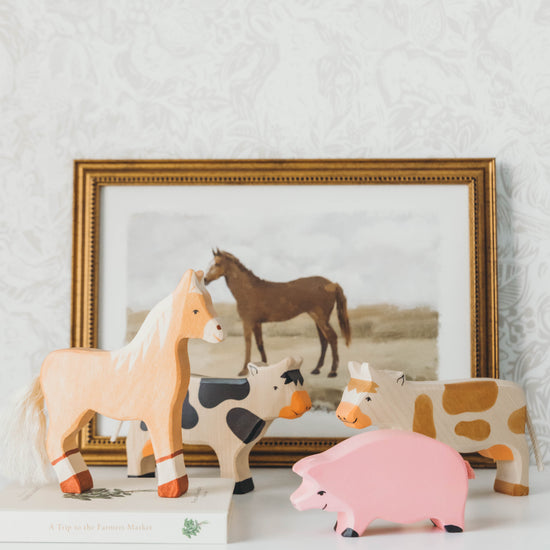 Farm Wooden Animal Set on a nightstand with a horse painting in the background