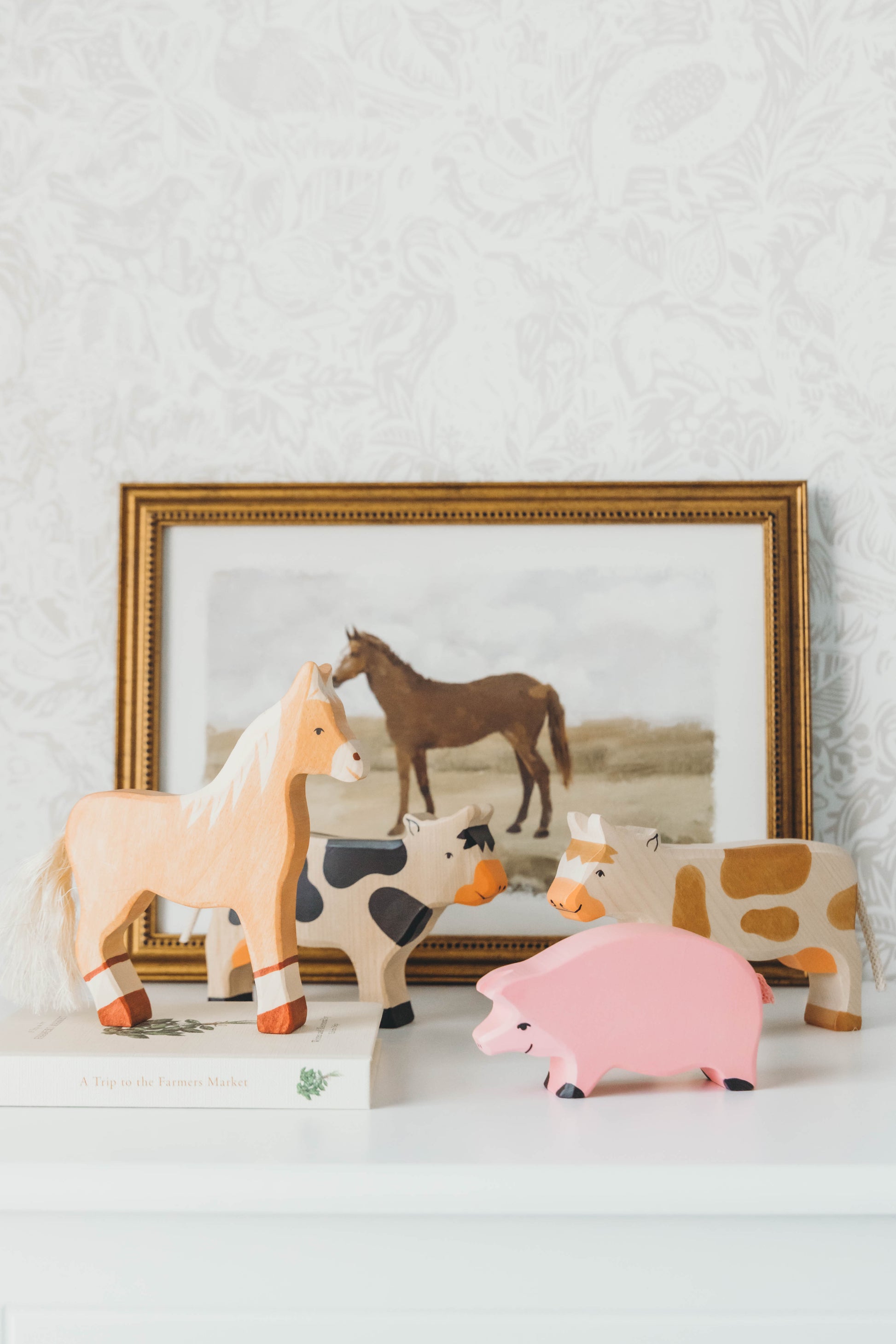 Farm Wooden Animal Set on a nightstand with a horse painting in the background