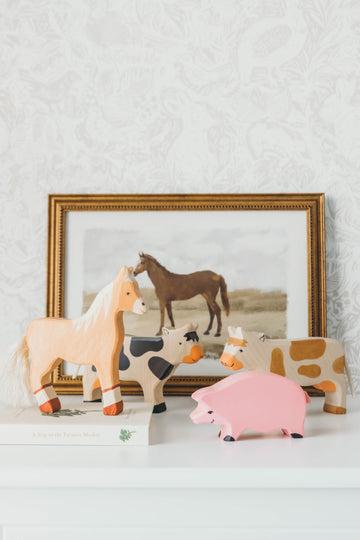 Farm Wooden Animal Set on a nightstand with a horse painting in the background