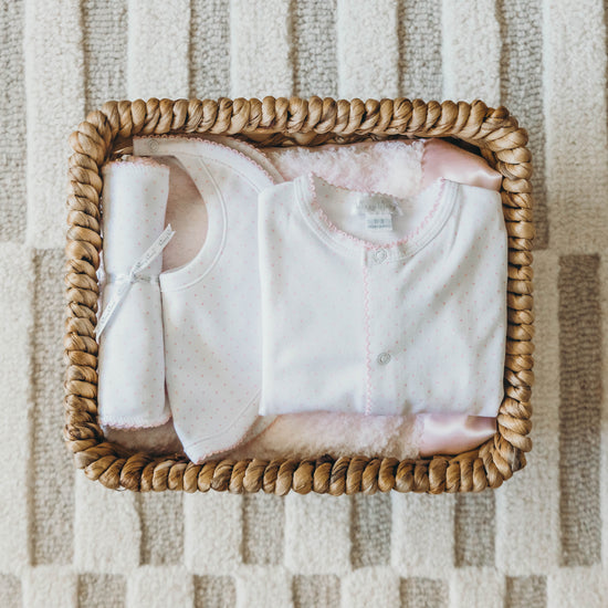 Polka dot 3-piece set for baby in a wicker basket