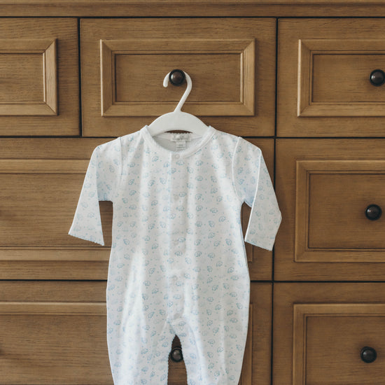 Elephant onesie in blue hanging on a dresser drawer knob