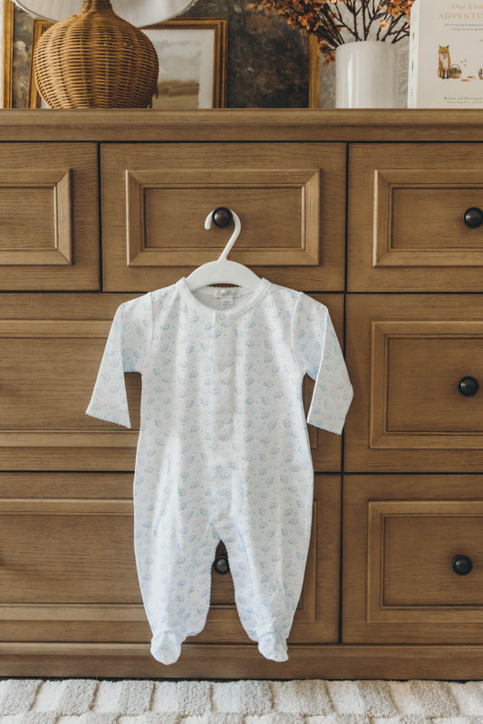 Elephant onesie in blue hanging on a dresser drawer knob